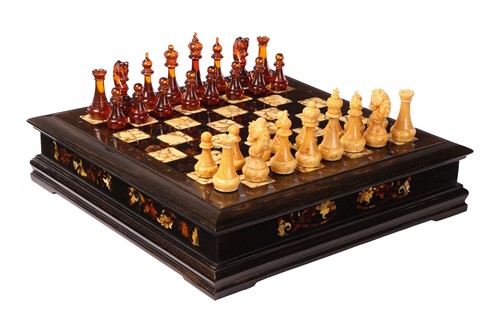 Lot 187 - A simulated amber chess set, late 20th century,...