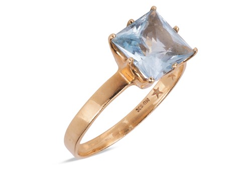 Lot A blue topaz single-stone ring, the four-claw...