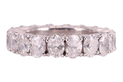 Lot An oval-cut diamond eternity ring, comprising...
