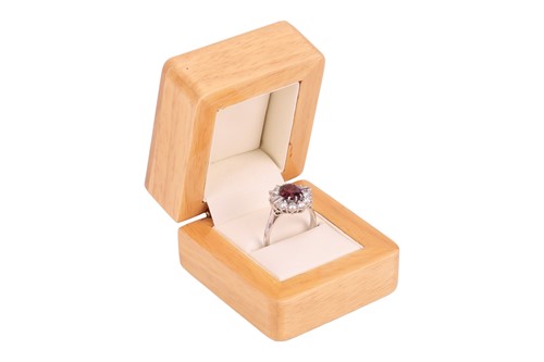 Lot A ruby and diamond cluster ring, centred with...