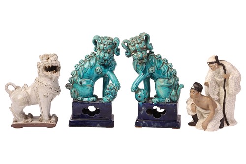 Lot 150 - A pair of turquoise-glazed lion dogs, 26 cm...