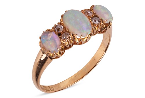 Lot 29 - An opal and diamond dress ring, set with three...