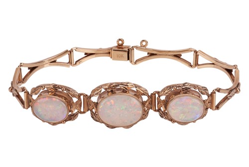 Lot 66 - An opal set bracelet; featuring three precious...