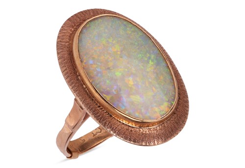 Lot 67 - An opal cocktail ring; featuring an oval...