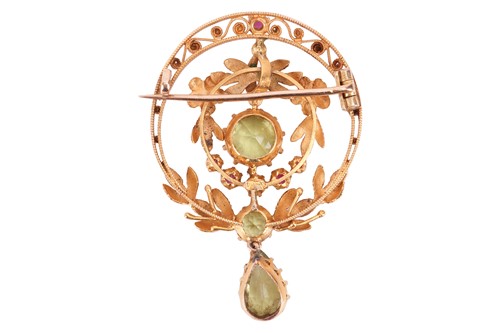 Lot A ruby and peridot brooch, of circular foliate...