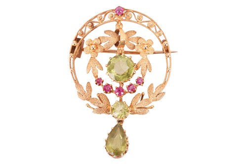 Lot 36 - A ruby and peridot brooch, of circular foliate...