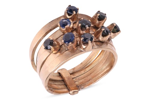 Lot 41 - A five row sapphire ring, each polished band...