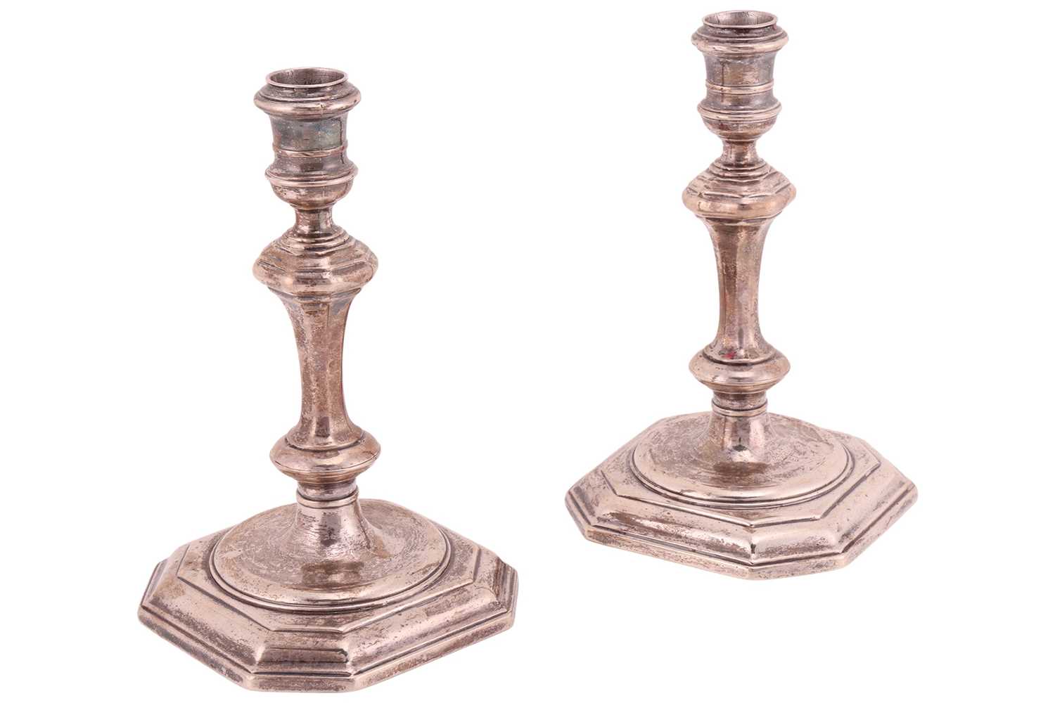 Lot A pair of George I silver cast candlesticks,...