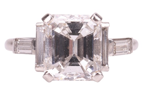 Lot An emerald-cut diamond dress ring, featuring...