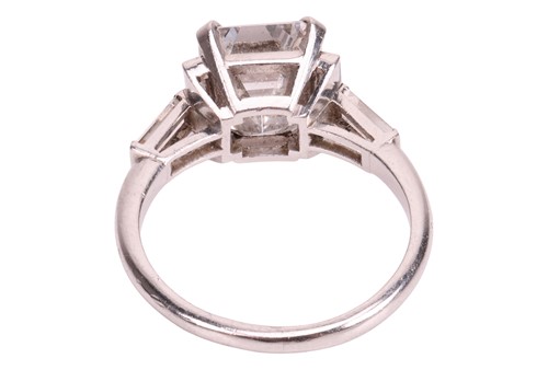 Lot An emerald-cut diamond dress ring, featuring...