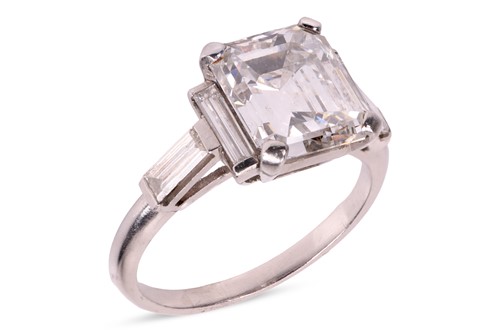 Lot An emerald-cut diamond dress ring, featuring...
