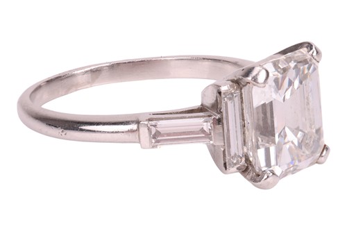 Lot An emerald-cut diamond dress ring, featuring...