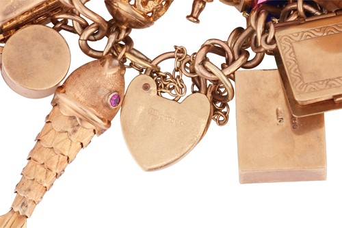 Lot A gold charm bracelet, including a 1911 half...
