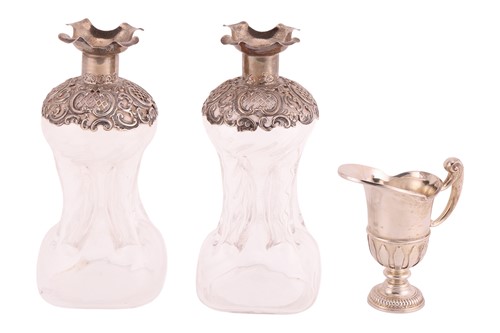 Lot 304 - A pair of Victorian silver-mounted ‘glug glug’...