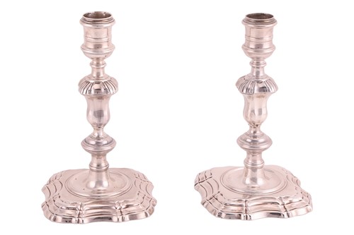 Lot A pair of George II silver cast candlesticks,...