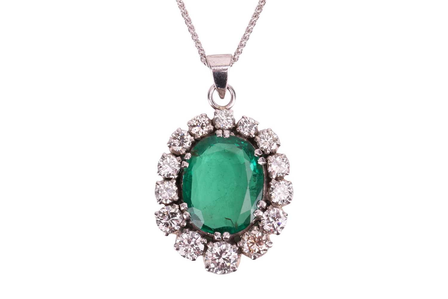 Lot An emerald and diamond pendant, in a cluster...