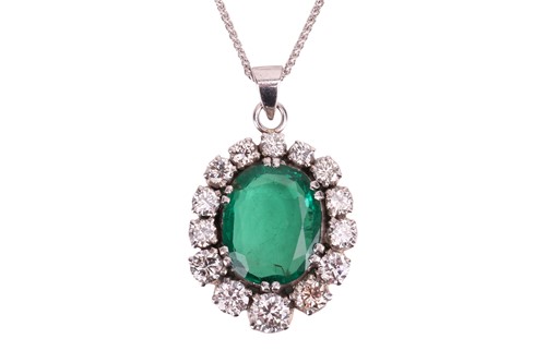 Lot An emerald and diamond pendant, in a cluster...