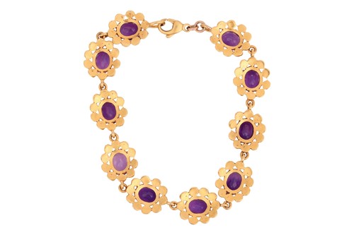 Lot 69 - An amethyst line bracelet, featuring ten oval...