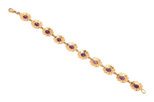 Lot 69 - An amethyst line bracelet, featuring ten oval...