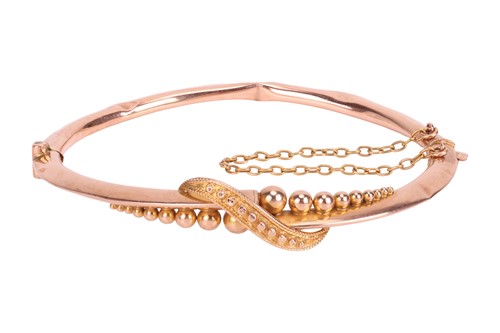 Lot 34 - An Edwardian bangle, the hollow bangle with...