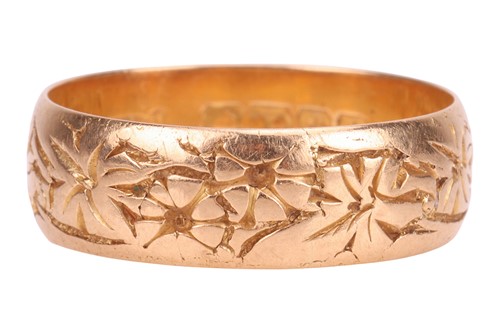 Lot 11 - An 18ct gold band ring, with engraved floral...
