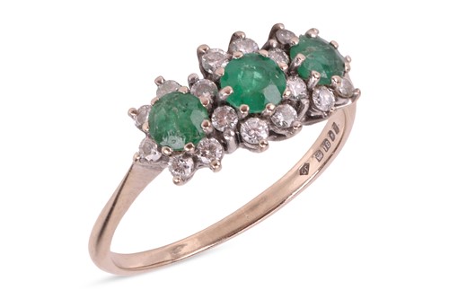 Lot 54 - An emerald and diamond ring, set with three...