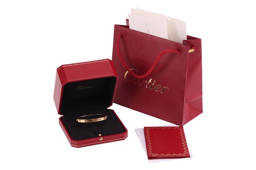 Lot 194 - Cartier - A 'LOVE' bangle in 18ct yellow gold,...