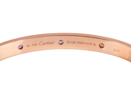 Lot 196 - Cartier - A rainbow 'LOVE' bangle, featuring...