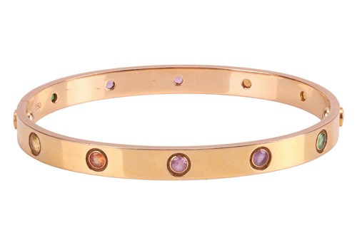 Lot 196 - Cartier - A rainbow 'LOVE' bangle, featuring...