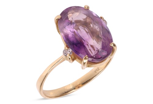 Lot 130 - An amethyst and diamond dress ring, claw-set...