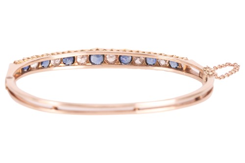 Lot 43 - An old-cut diamond and sapphire hinged bangle,...