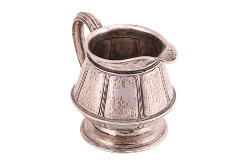 Lot 240 - An Arts and Crafts silver cream jug, London...