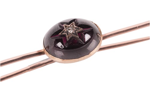 Lot An amethyst and diamond bar brooch, the...