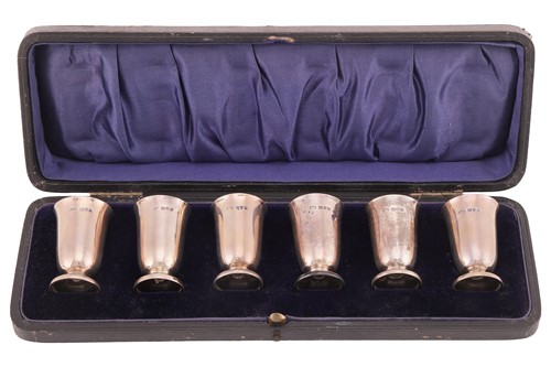 Lot 222 - A set of six cased George V silver whisky tots,...
