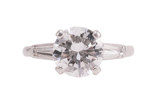 Lot A diamond solitaire ring, featuring a central...