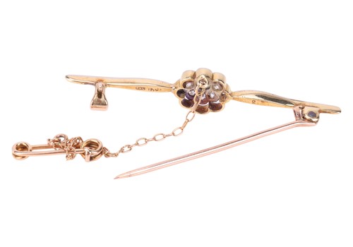 Lot A diamond-set bar brooch, featuring a central...