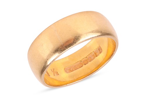 Lot 78 - A wedding band in 22ct yellow gold, comprising...