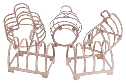 Lot 249 - Five silver toast racks; to include a pair of...