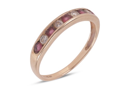 Lot 106 - A 9ct gold ruby and diamond half eternity ring,...