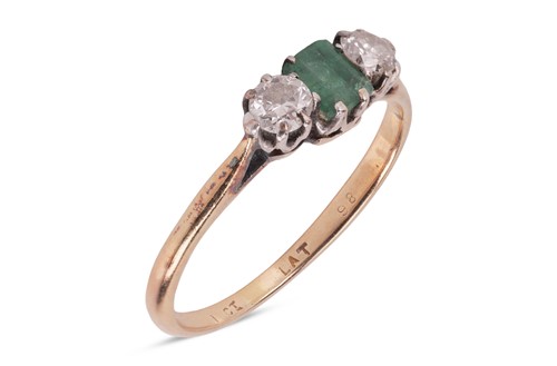 Lot 7 - An emerald and diamond trilogy ring, featuring...
