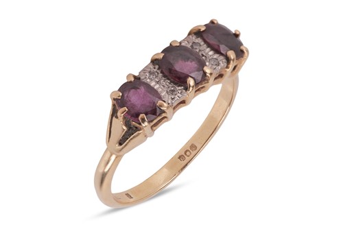 Lot 90 - A ruby and diamond-set ring, featuring three...