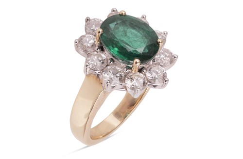 Lot 198 - An emerald and diamond cluster ring, featuring...