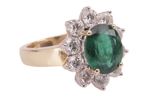 Lot 198 - An emerald and diamond cluster ring, featuring...