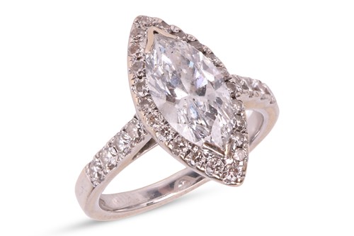 Lot A diamond solitaire ring, featuring a central...