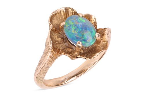 Lot 91 - An opal triplet ring; featuring an oval...