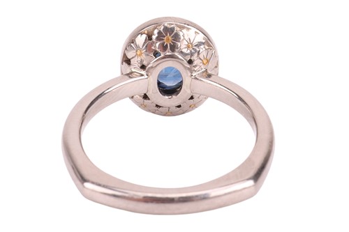 Lot 135 - A sapphire & diamond cluster ring, featuring a...