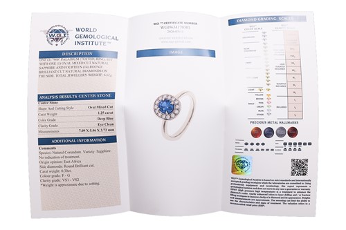 Lot 135 - A sapphire & diamond cluster ring, featuring a...