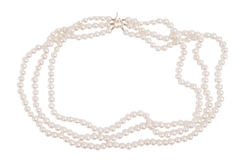 Lot 62 - A three-row cultured pearl necklace, featuring...