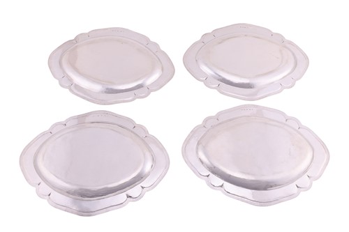Lot A set of four George III Scottish silver meat...