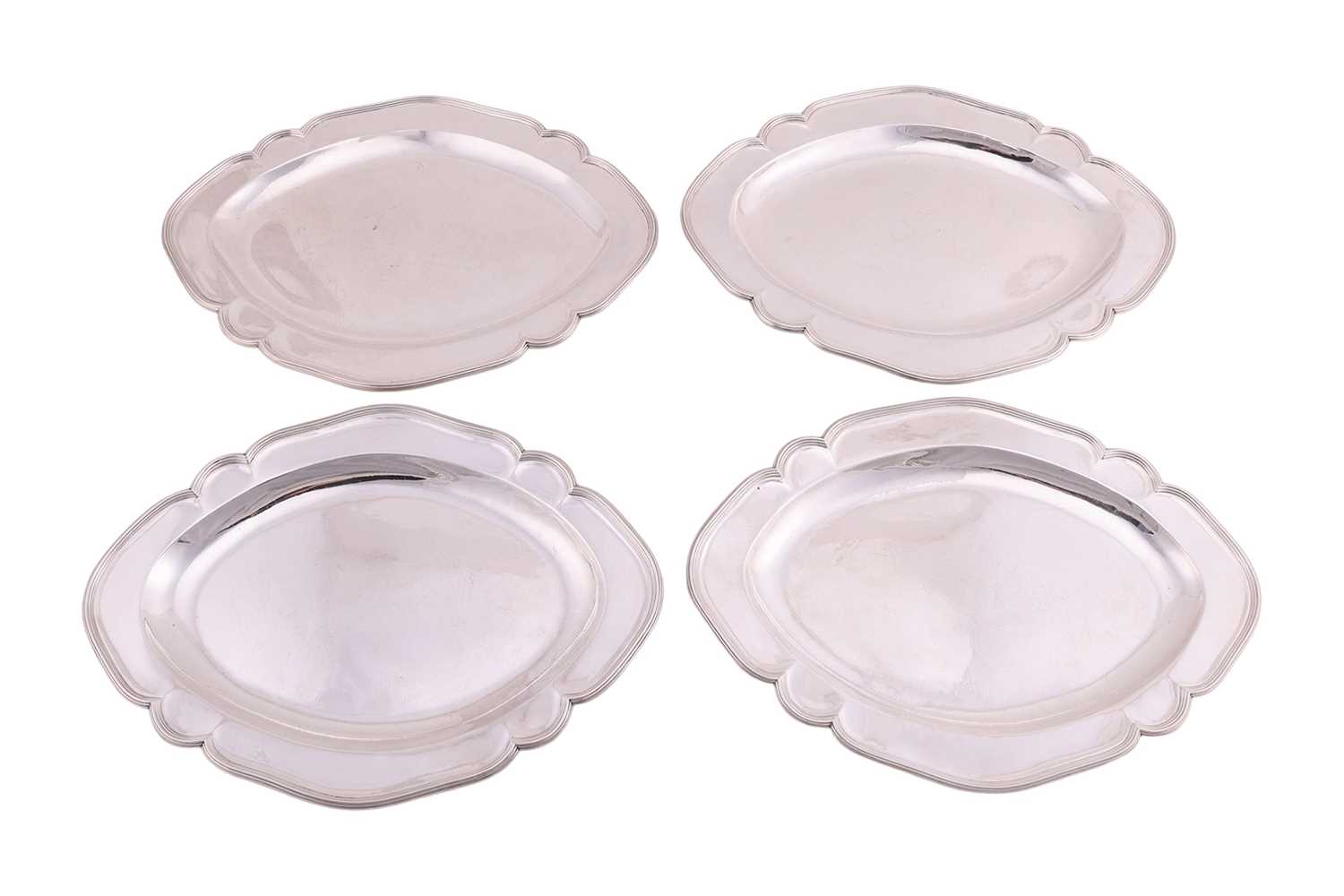 Lot A set of four George III Scottish silver meat...